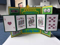 Handmade fold-out birthday card standing open with five panels showing a hand of hearts from ace to ten, a marquee Happy Birthday sign, dice, chips, and It’s a Big Deal in green and yellow
