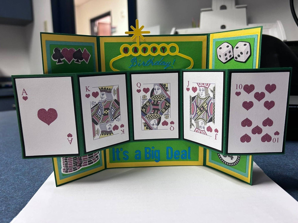 Handmade fold-out birthday card standing open with five panels showing a hand of hearts from ace to ten, a marquee Happy Birthday sign, dice, chips, and It’s a Big Deal in green and yellow