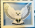 Handmade snowy owl layered paper shadow box with wings spread wide in a white frame